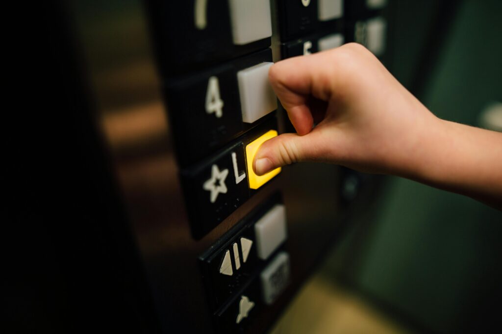 pexels-photo-3861787-3861787 Anonymous person pressing button of lift
