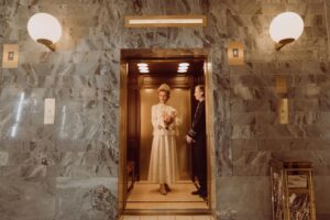 Woman in White Dress Standing on Brown Wooden Door